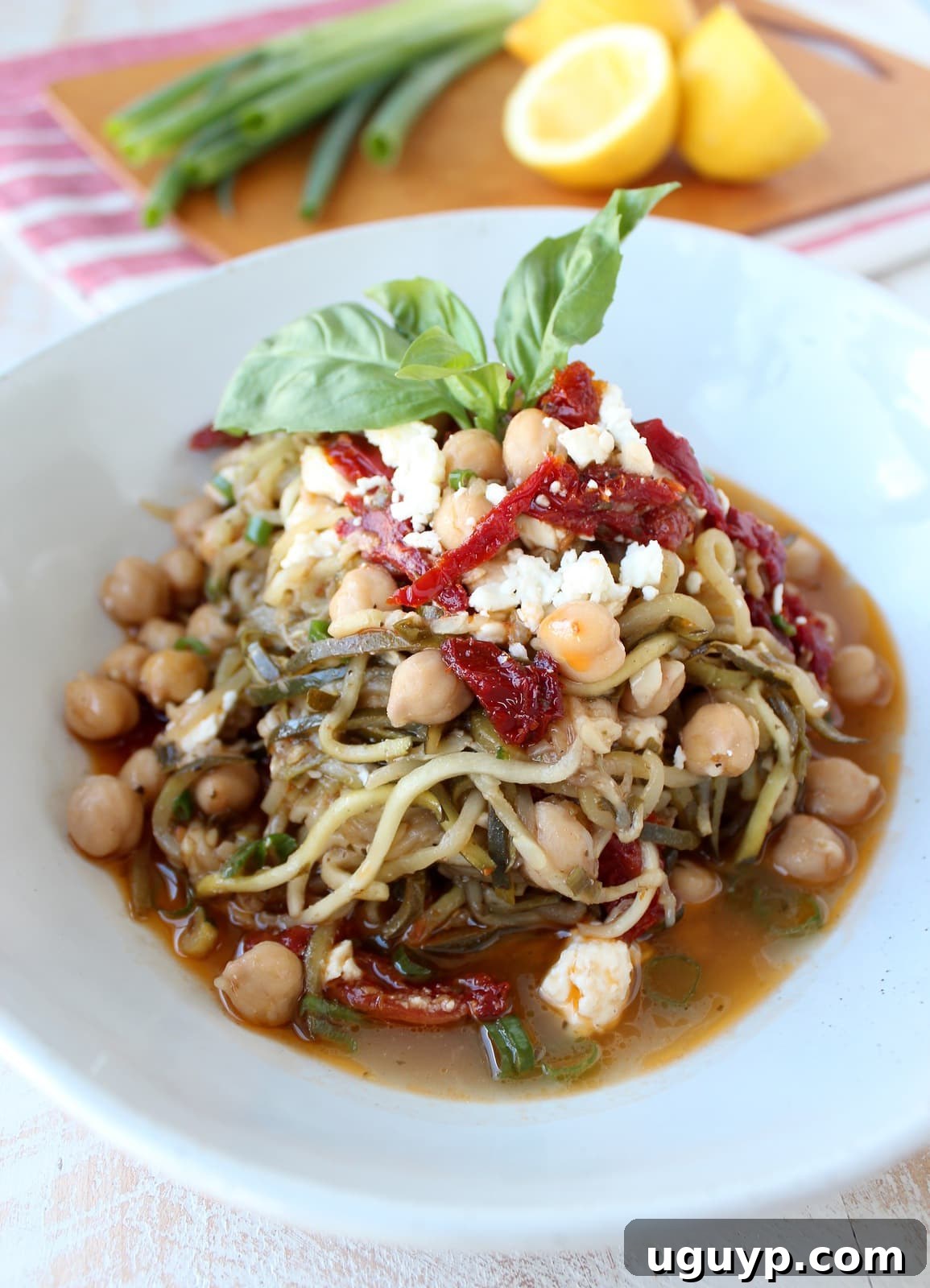 Greek Zucchini Noodles in a bowl with feta cheese and sun dried tomatoes