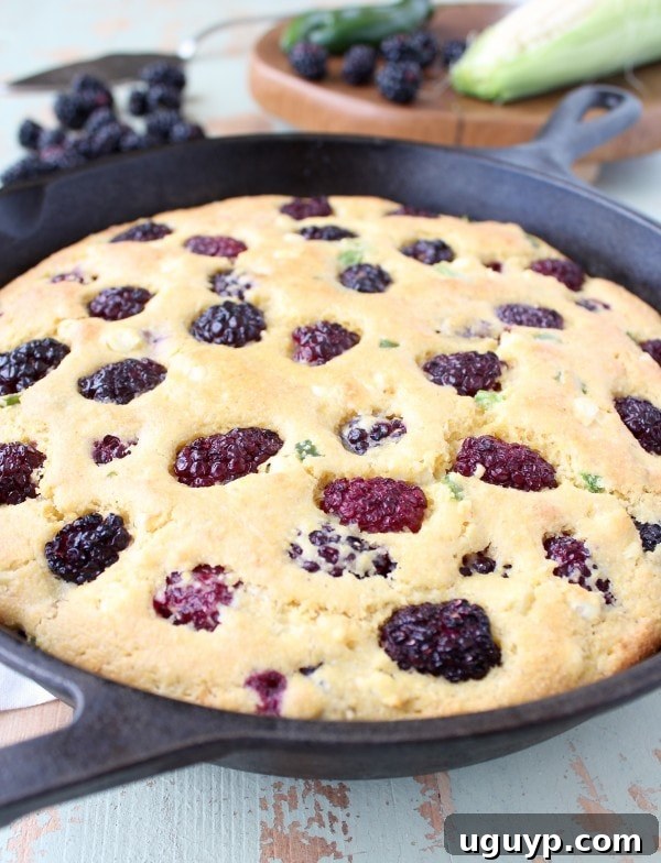 Another view of Blackberry Serrano Cornbread on a wooden surface