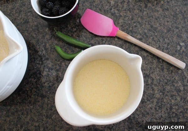 Wet ingredients for Blackberry Serrano Cornbread mixed in a bowl