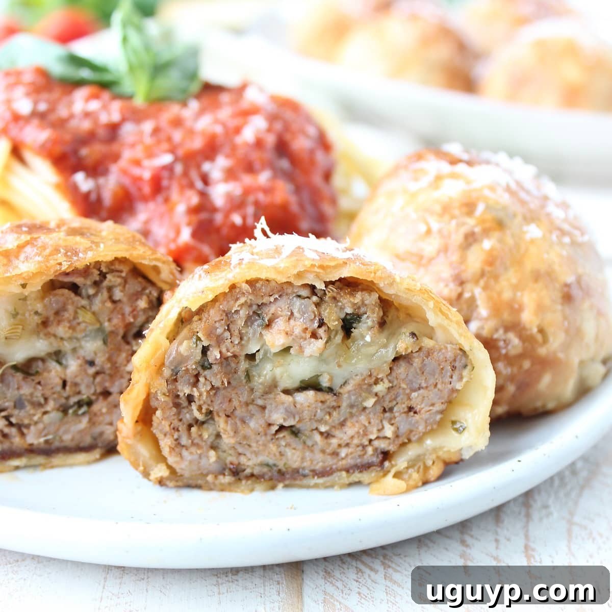 Meatball Wellington cut in half on plate