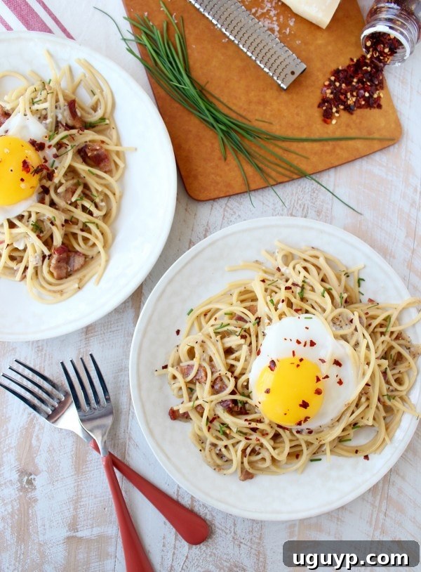Cracking the egg yolk over One Pot Pasta Carbonara