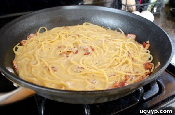 Mixing Parmesan cheese into One Pot Pasta Carbonara
