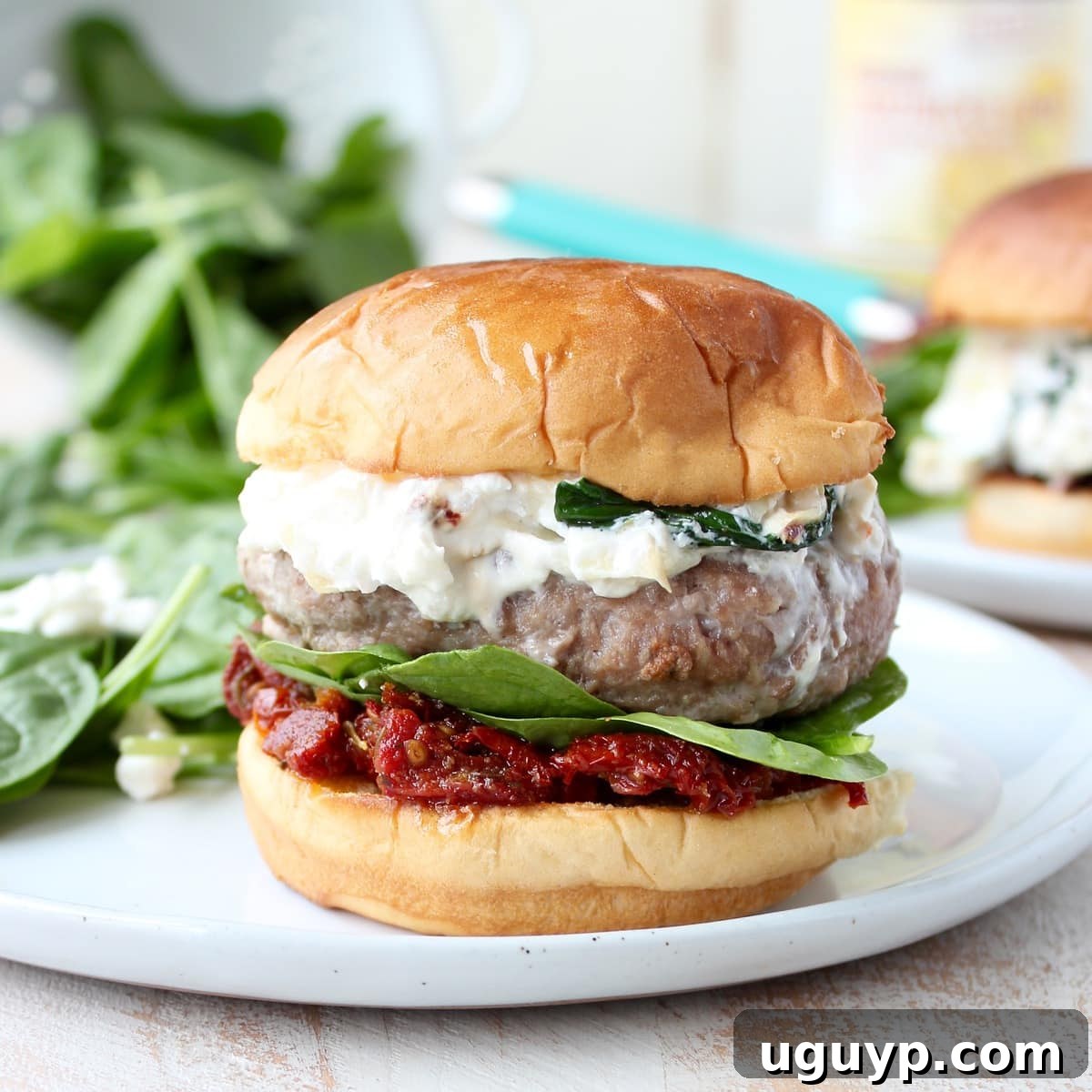 Multiple Spinach Artichoke Dip Turkey Burgers on a tray, ready to be served at a party