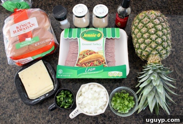 Ingredients for Hawaiian Turkey Burgers laid out, including ground turkey, fresh pineapple, jalapenos, onions, and King's Hawaiian buns.