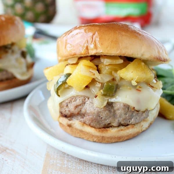 A perfectly assembled Hawaiian Turkey Burger with relish and cheese, ready to be eaten.