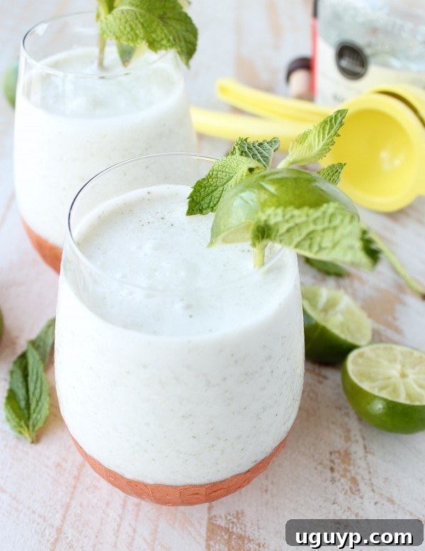 Close-up of a beautifully garnished Frozen Coconut Mojito