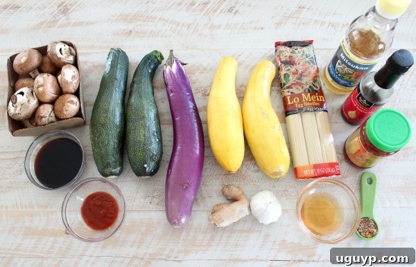 All the ingredients laid out on a table, including fresh vegetables, noodles, and sauce components