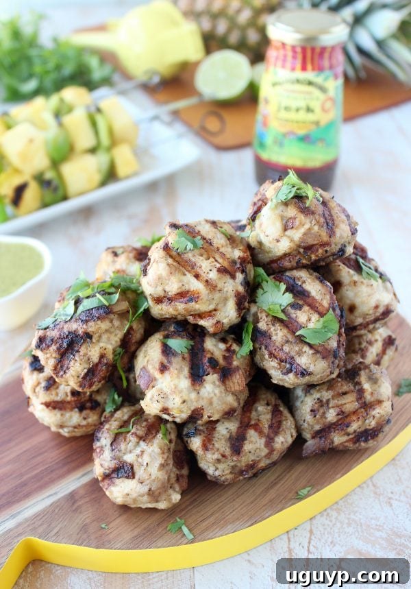 Jerk Chicken and Pork Meatballs Dish with Grilled Pineapple and Peppers on a Plate