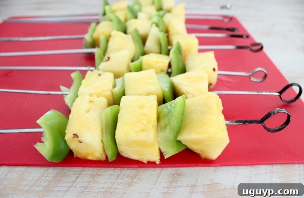 Assembling Colorful Bell Pepper and Pineapple Skewers for Grilling