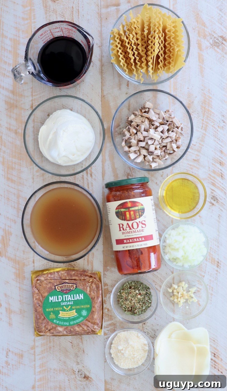 Assorted fresh ingredients for a quick skillet lasagna, including diced vegetables, Italian sausage, noodles, and cheeses, laid out on a white wooden background.