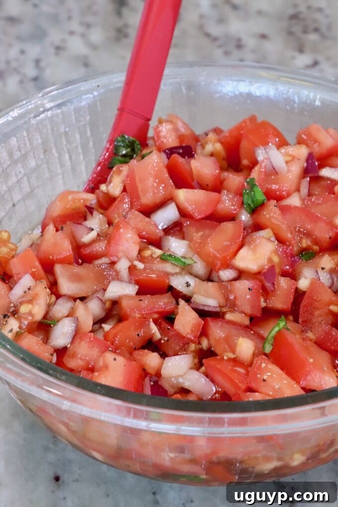 tomato bruschetta mixed together in a glass bowl