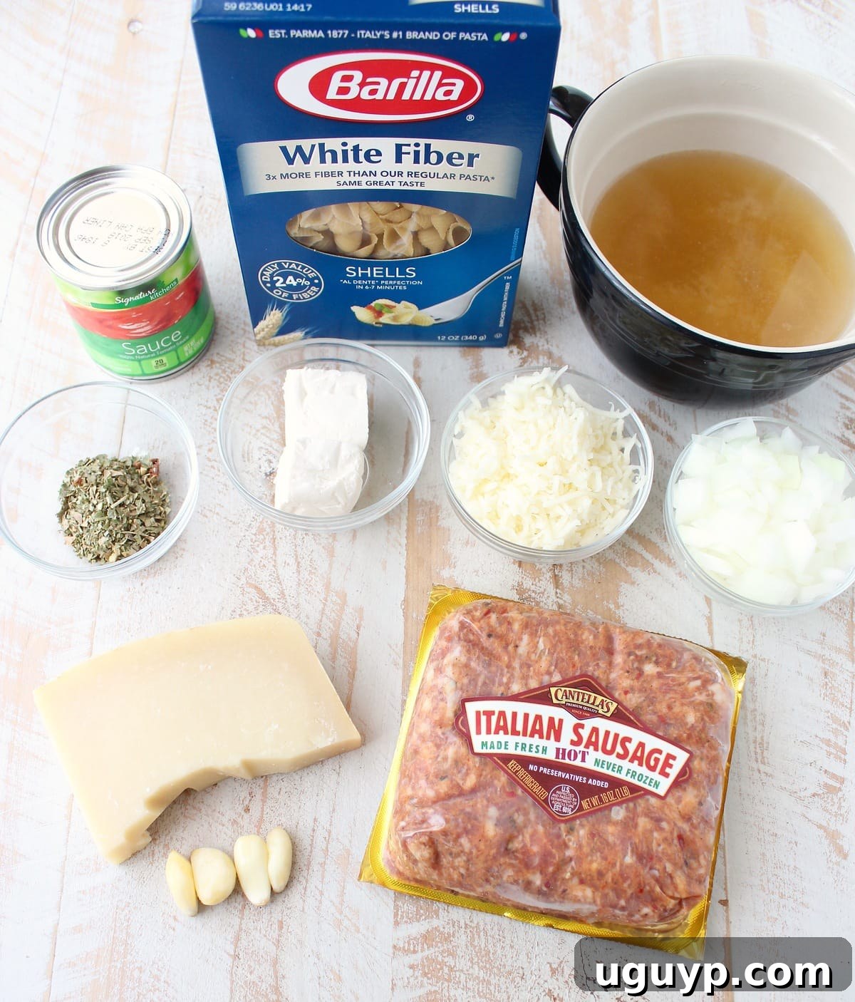 Italian Sausage Shells and Cheese Ingredients on a white wood board