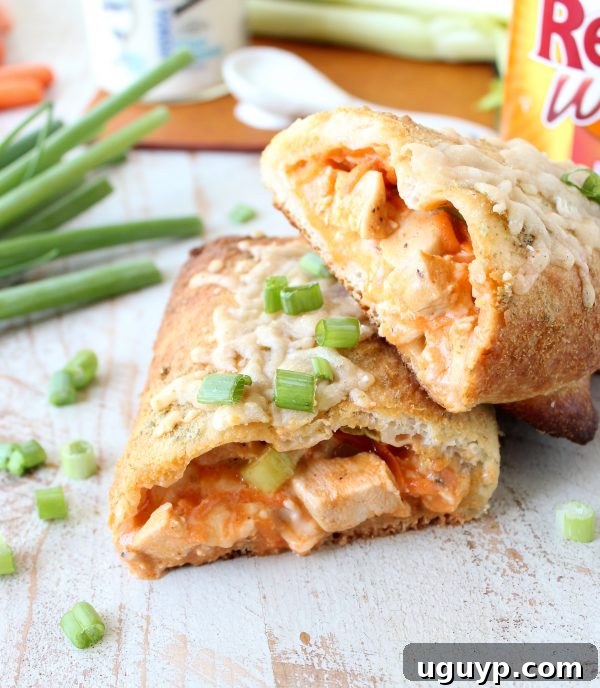 Two halves of a buffalo chicken bake stacked together on a wooden surface.