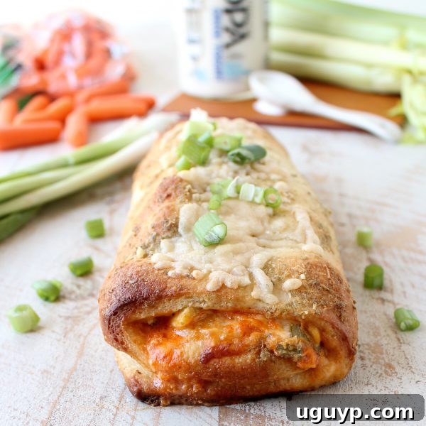 Buffalo Chicken Bake on a wooden surface garnished with green onions.