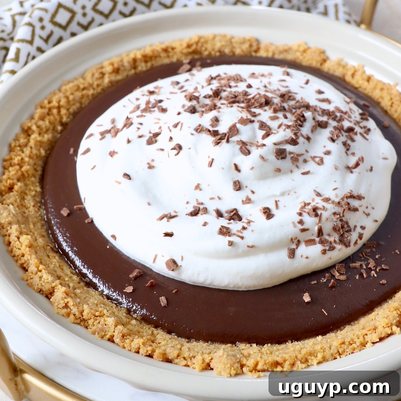 chocolate pie topped with whipped cream in pie plate