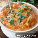 cooked butter chicken in bowl with spoon
