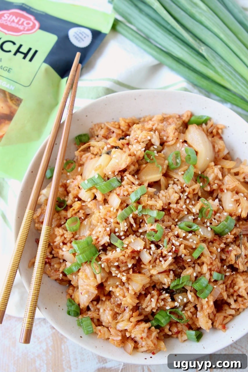 Overhead shot of Kimchi Fried Rice in bowl with chopsticks