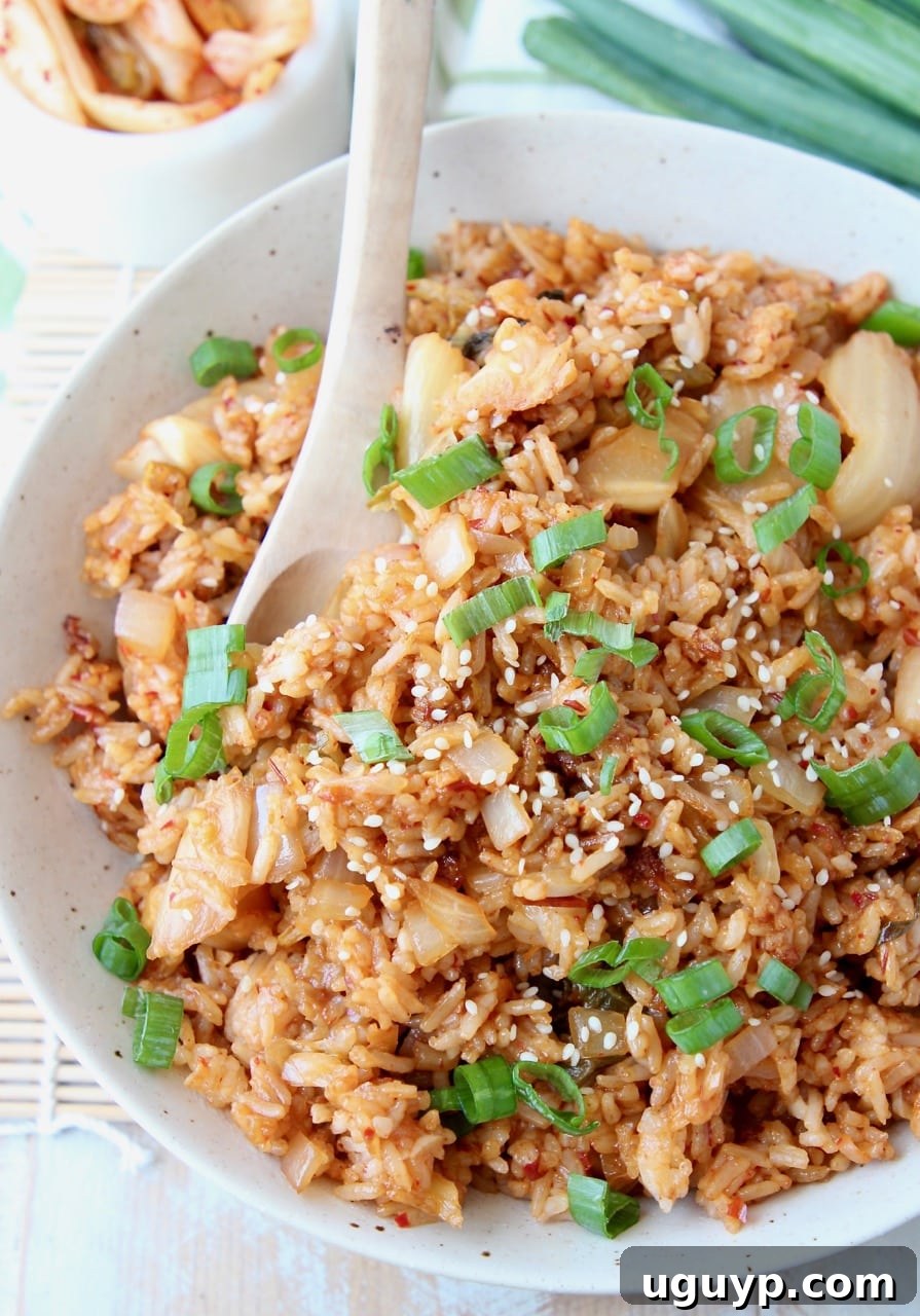 Overhead shot of kimchi fried rice in bowl with spoon