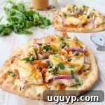 This easy naan pizza recipe is made in under 30 minutes with Thai peanut chicken, red onion, pineapple & mozzarella for a delicious combination of flavors!