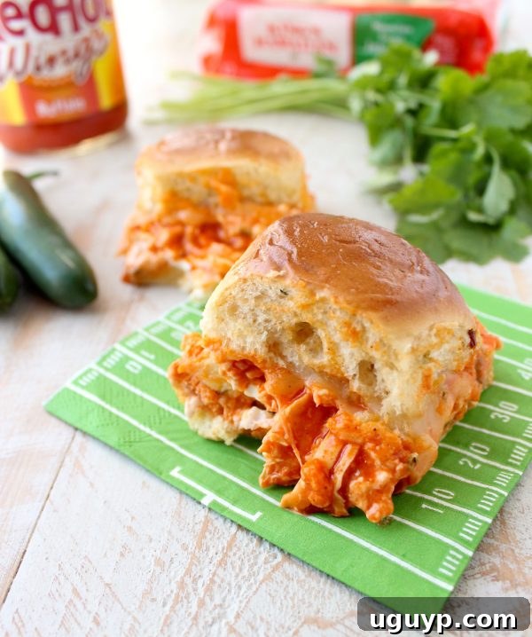 Close-up of the delicious layers of Buffalo Chicken Dip Sliders before baking.