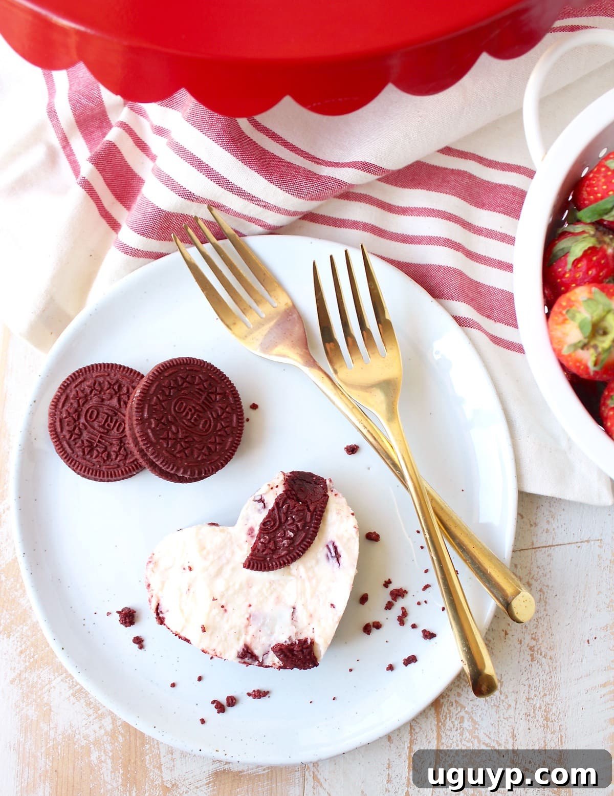 Assorted heart-shaped Red Velvet Oreo cheesecake bars arranged on a plate, ready for a delightful dessert.