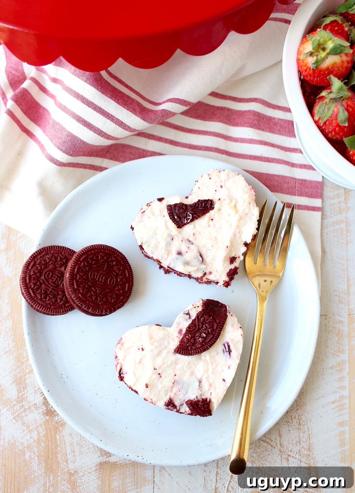 Red Velvet Oreo cheesecake bars on a decorative plate, ready to be enjoyed.