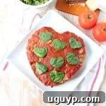 Heart-shaped Italian Meatloaf with a marinara glaze, ready to serve.