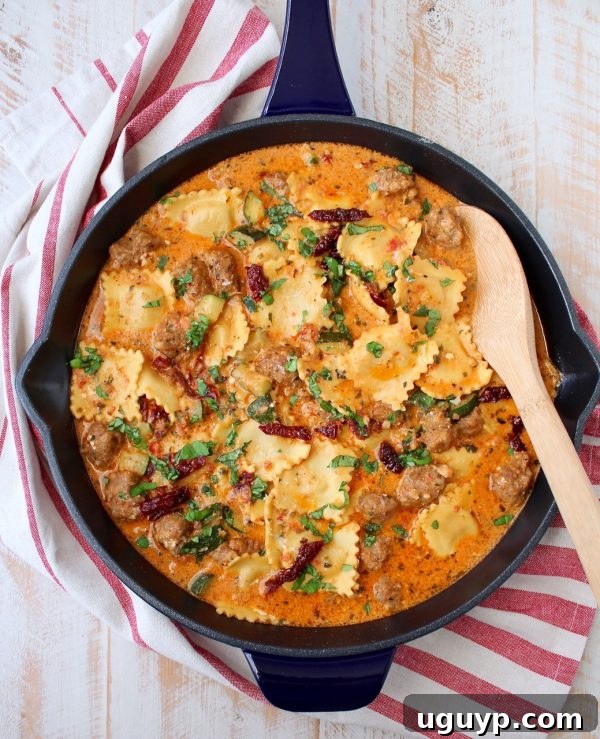 The finished One Pot Ravioli dish in a rustic skillet, topped with fresh basil, ready for serving.