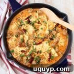 One Pot Ravioli with Creamy Pesto Sauce and Sausage in a serving bowl.