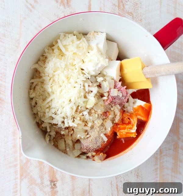 ingredients for buffalo cheesy meatloaf in large mixing bowl with spatula