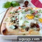 Crispy pizza crust, flavorful turkey sausage, sautéed veggies, baked eggs & parmesan cheese make up this deliciously easy breakfast pizza recipe!