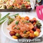 Finished Sheet Pan Salmon with Thai Sweet Chili Sauce and roasted vegetables on a platter.
