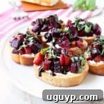 A toasted baguette is topped with goat cheese, balsamic roasted beets, fresh basil & balsamic reduction in this vegetarian Beet Bruschetta recipe that's perfect for Spring!