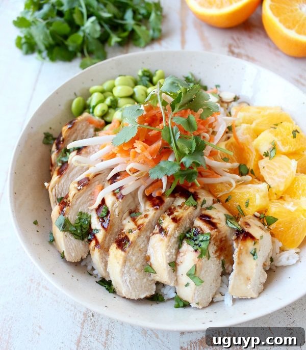 Sesame ginger marinated & grilled chicken tops these Healthy Asian Chicken Rice Bowls filled with oranges, almonds, veggies & tons of flavor!