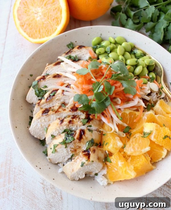 Sesame ginger marinated & grilled chicken tops these Healthy Asian Chicken Rice Bowls filled with oranges, almonds, veggies & tons of flavor!