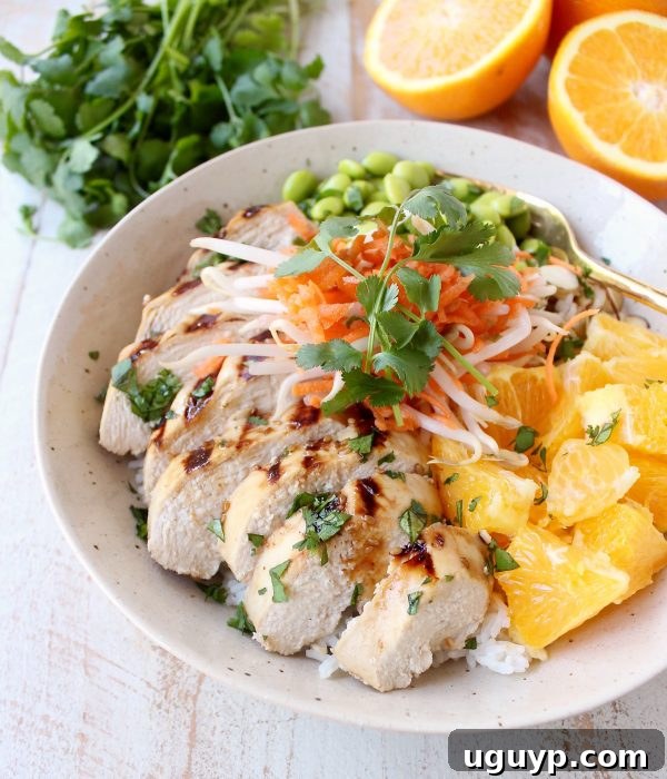 Sesame ginger marinated & grilled chicken tops these Healthy Asian Chicken Rice Bowls filled with oranges, almonds, veggies & tons of flavor!