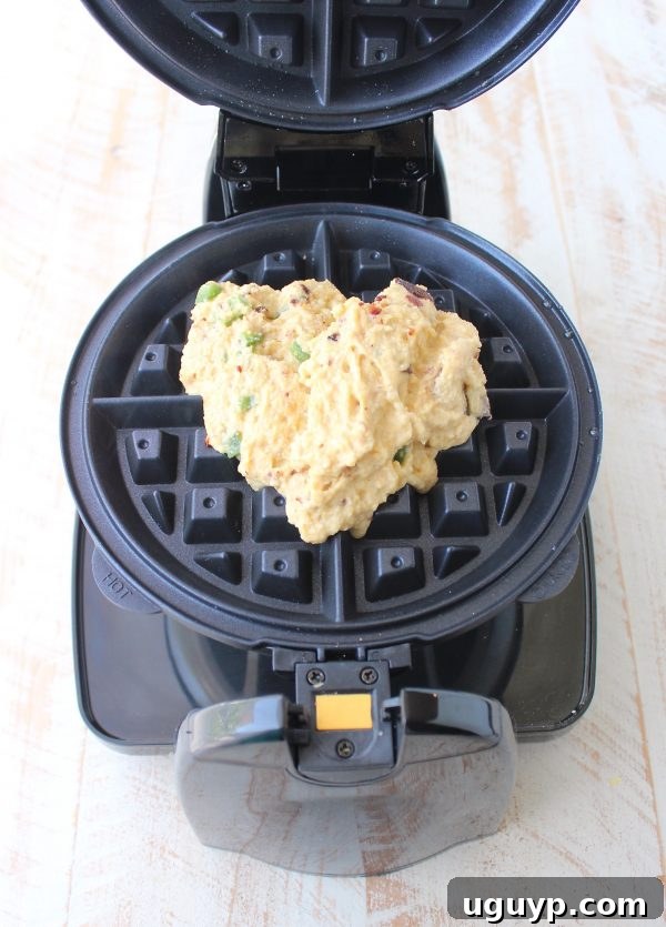 Waffles cooking in the iron.
