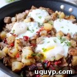 Leftover Bacon Wrapped Meatloaf is transformed into one seriously delicious one pot breakfast in this Meatloaf Hash Recipe with potatoes, onions & eggs!