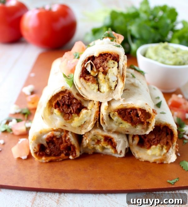 Crispy Breakfast Taquitos filled with chorizo, scrambled eggs, and pepper jack cheese, ready to be served on a platter.