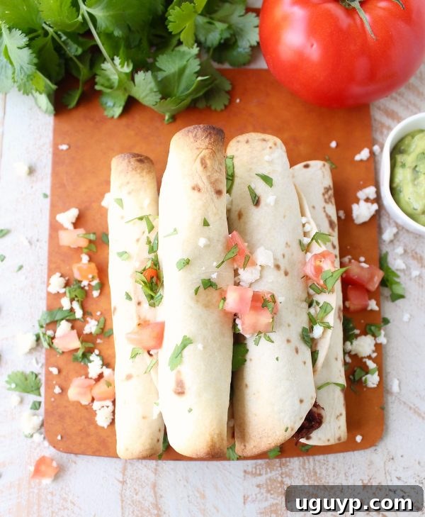 Freshly baked Breakfast Taquitos with golden-brown, crispy tortillas, straight out of the oven.