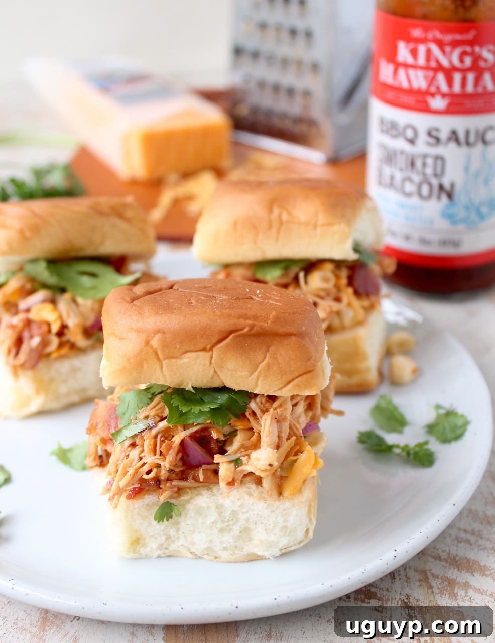 Delicious BBQ Chicken Salad Sliders piled high on sweet Hawaiian rolls, ready to be served at a summer gathering.