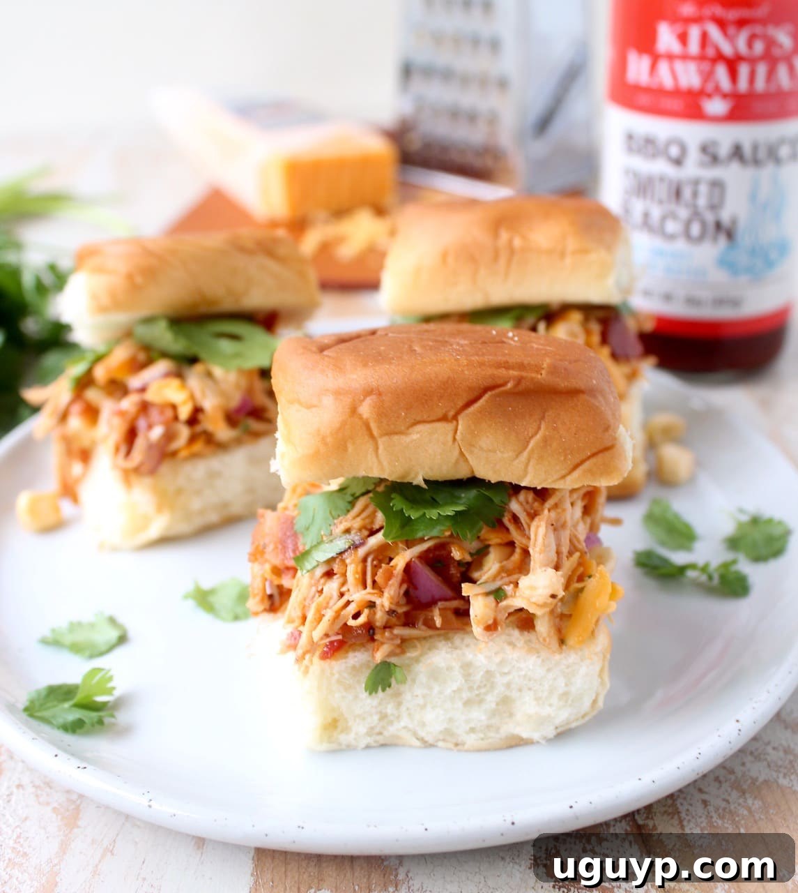 Hands reaching for BBQ Chicken Salad Sliders, showing the perfect grab-and-go snack.