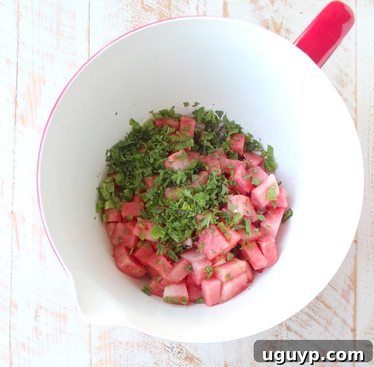All the diced watermelon salsa ingredients gathered in a large mixing bowl, ready to be tossed.
