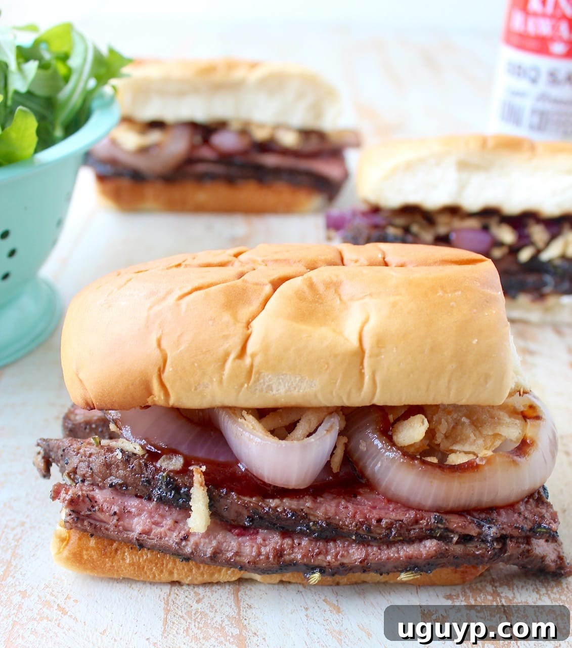 grilled steak sandwiches on white wood board
