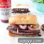 Thin slices of coffee rubbed, grilled steak are piled up with herbed goat cheese, BBQ sauce & grilled onions in this mouth-watering steak sandwich recipe!