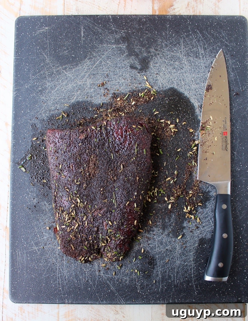 coffee rubbed skirt steak on cutting board with knife
