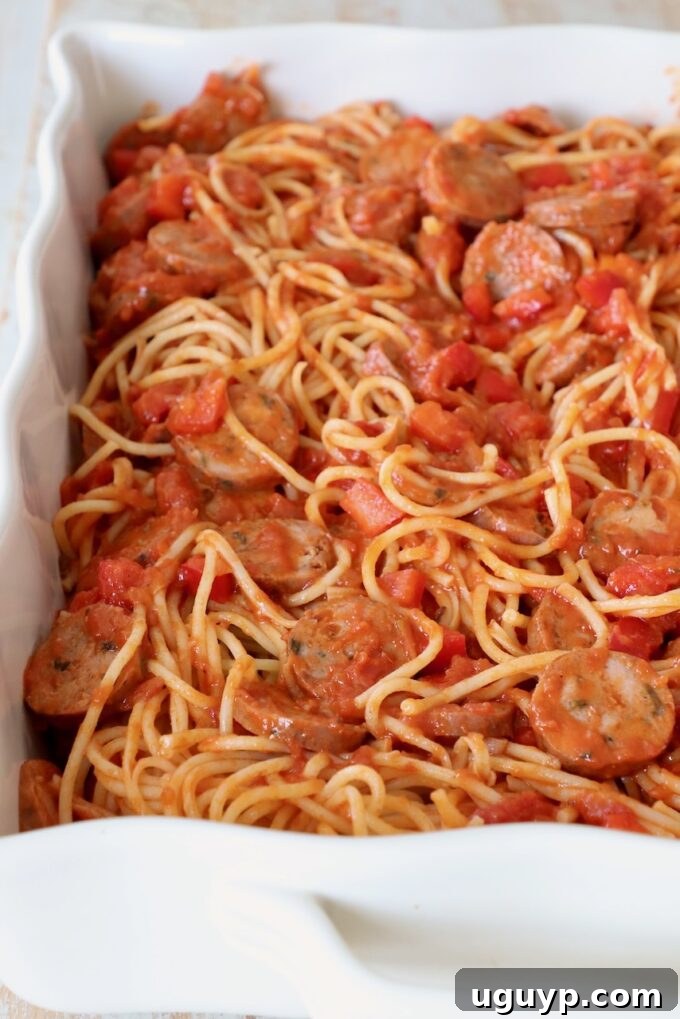 The spaghetti mixture transferred into a casserole dish, ready for the cheese topping.