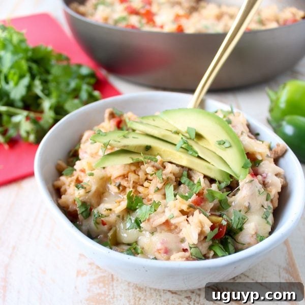 A vibrant One Pot Turkey Taco Rice Skillet, packed with ground turkey, rice, colorful veggies, and melted pepper jack cheese, ready to serve as a quick and easy weeknight dinner.