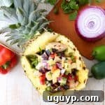 Grilled chicken teriyaki is served over zucchini noodles and topped with pineapple salsa in these healthy, gluten free and delicious zoodle bowls!