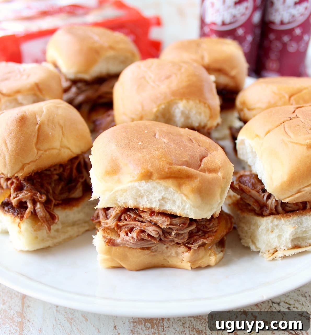 A plate of Dr Pepper Pulled Pork Sliders with vibrant toppings, showcasing the deliciousness of the shredded pork.